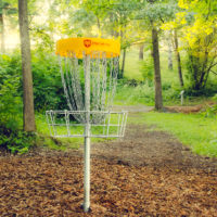 A photo of a hole at the disc golf course at Camp Canaan .