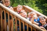 junior day campers line up on the stairs of the double decker dock at Camp Canaan