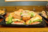 catered sandwiches are laid out on tiki bar in the pavilion by the pool at Camp Canaan