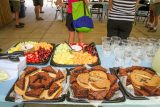 catered food is laid out on tables in the pavilion by the pool at Camp Canaan