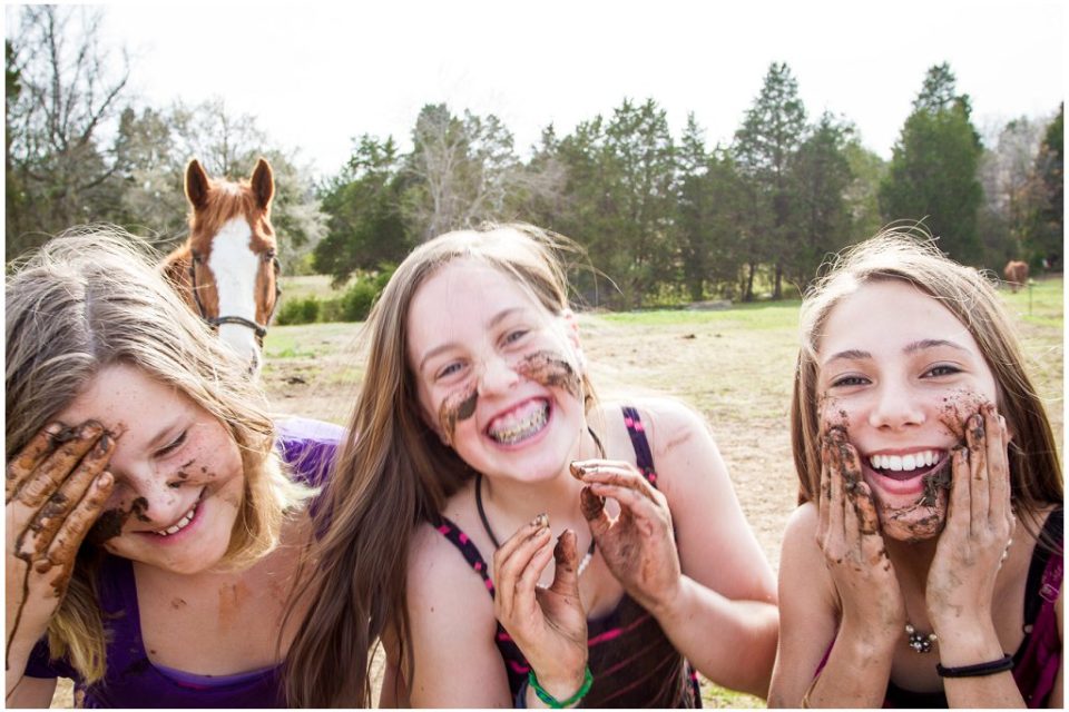 girls smile with dirt on their faces