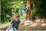 man receives training on zipline canopy tour before enjoying zipline for corporate outing