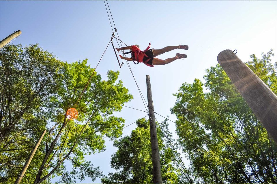 camper jumps for leap of faith on the high ropes course at Camp Canaan