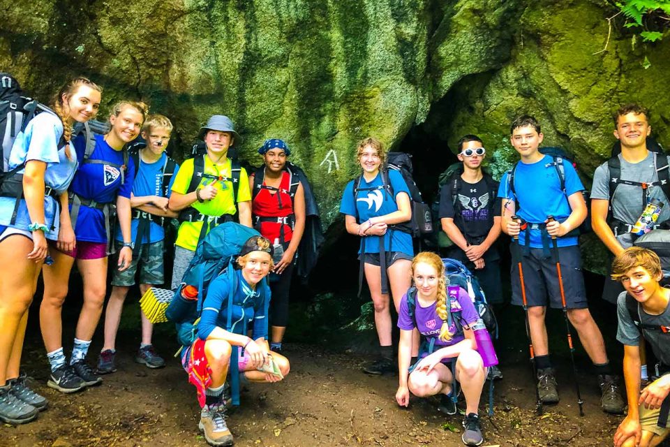 TLC campers pose in front of rocks during hike