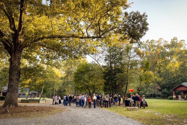 people gather outside under a beautiful tree for a retreat at Camp Canaan