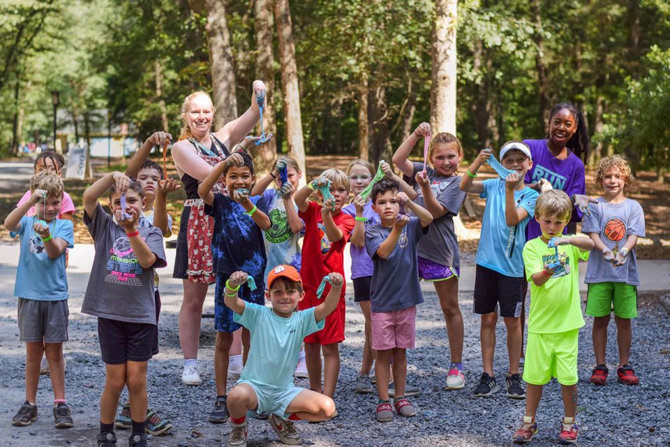 group of junior day campers show off the slime they made for a craft at Camp Canaan