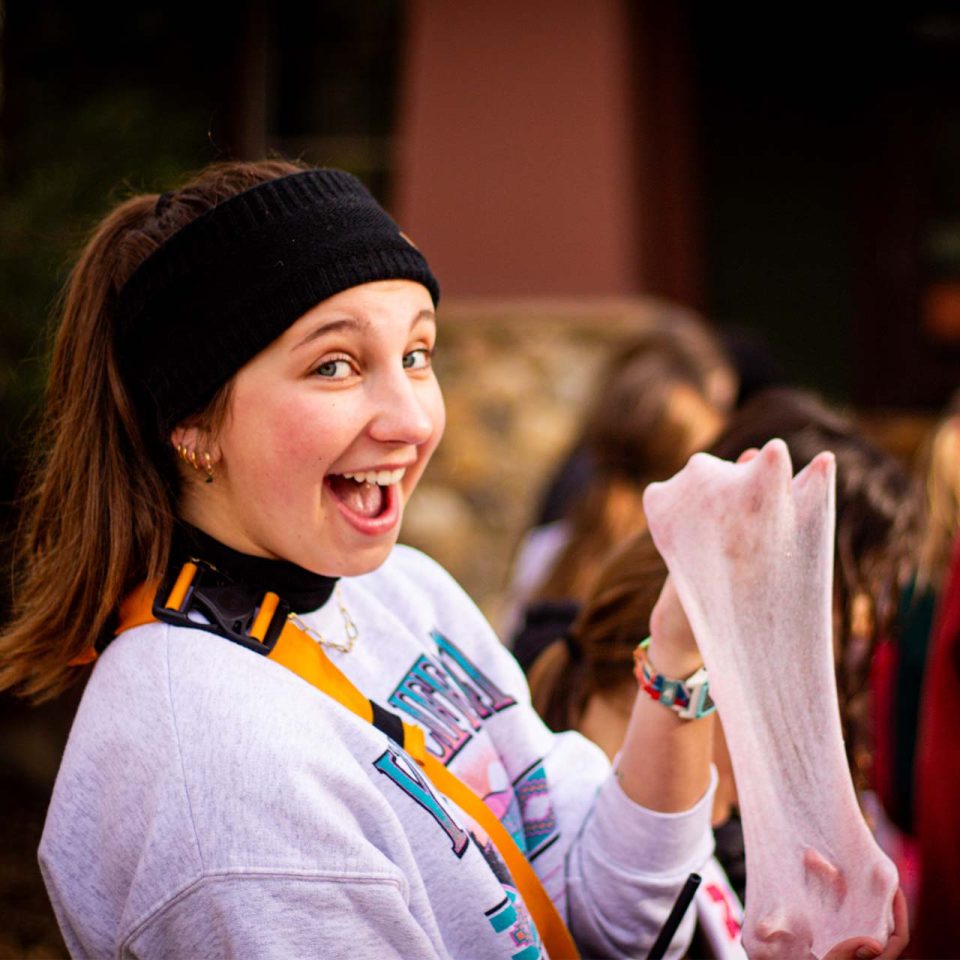 counselor shows off pink slime she made at winter camp