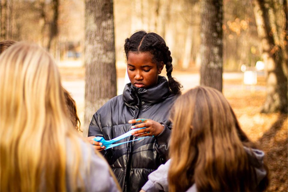 camper plays with blue slime that she made during winter camp at Camp Canaan