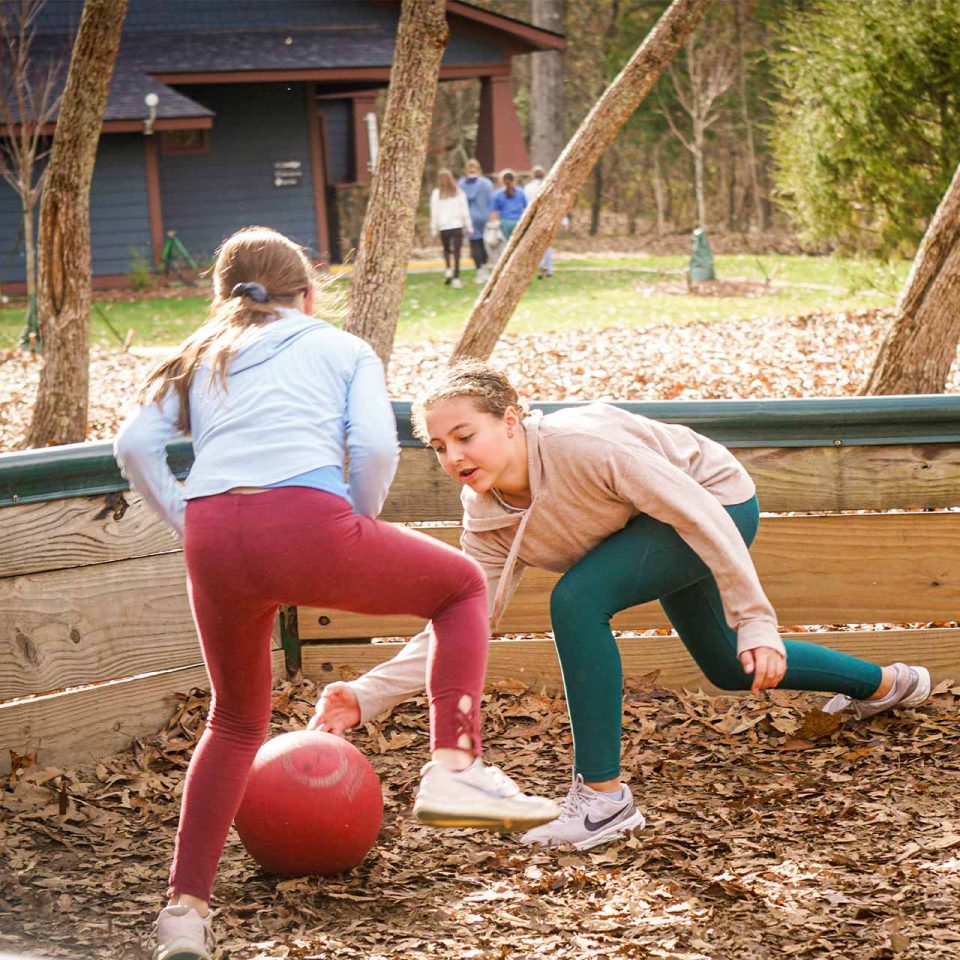 female campers play GaGa ball in the GaGa ball pit during winter camp at Camp Canaan