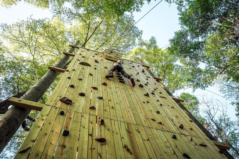 young adult rock climbs up the Catawba Tower