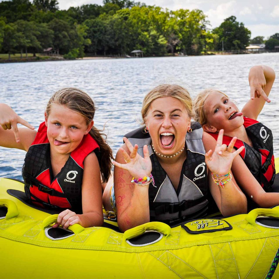 counselor has fun tubing with her campers during all girls week