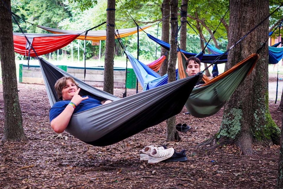 legacy campers chill in eno hammocks in the trees of Camp Canaan during summer camp