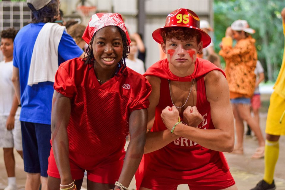 counselor and assistant counselor pose dressed all in red