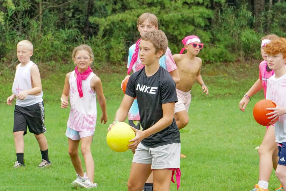 campers play games in sports field during summer camp at Camp Canaan