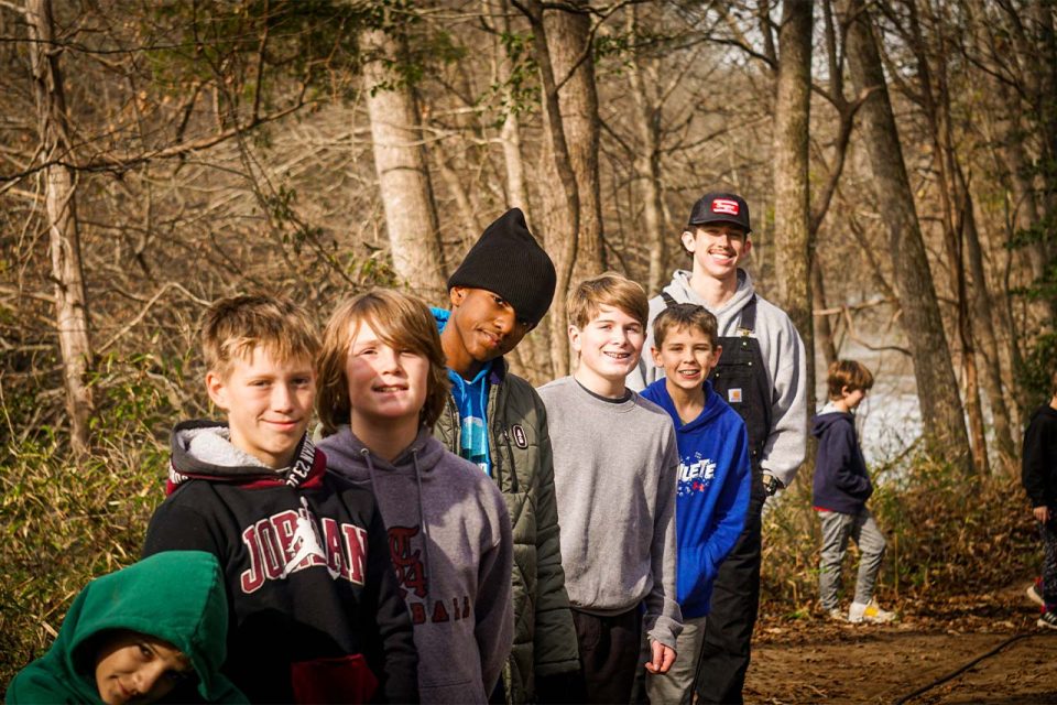 group of winter camp campers hang out on the walking trails at Camp Canaan