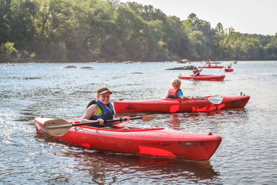 young campers paddle along the Catawba River in red kayaks during Camp Canaan kayaking adventure