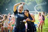 Kat Bowen sprays shaving cream on fellow counselor during sludge wars at Camp Canaan