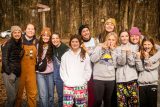 group of counselors and winter camp campers line up in front of sandy road at Camp Canaan during winter camp