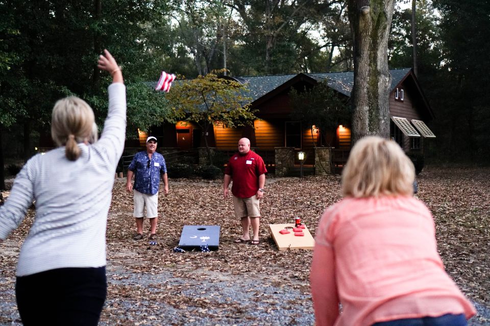 adults play corn hole during overnight retreat at Camp Canaan