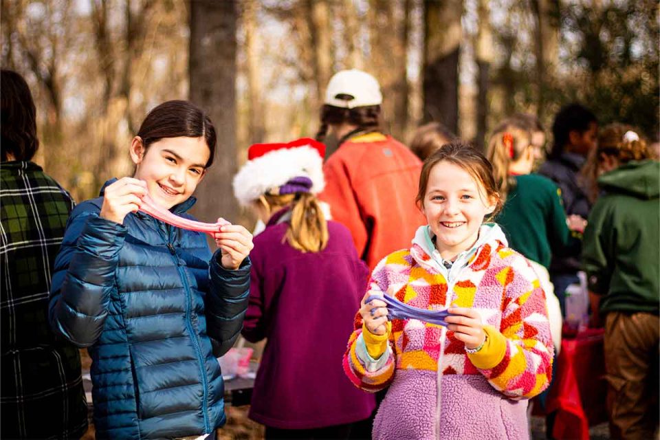 girl campers show off the slime they made during winter camp at Camp Canaan