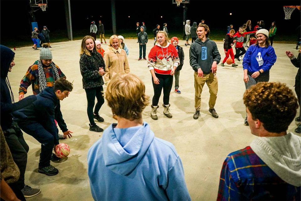 counselors circle up for night games at the basketball pavilion during winter camp