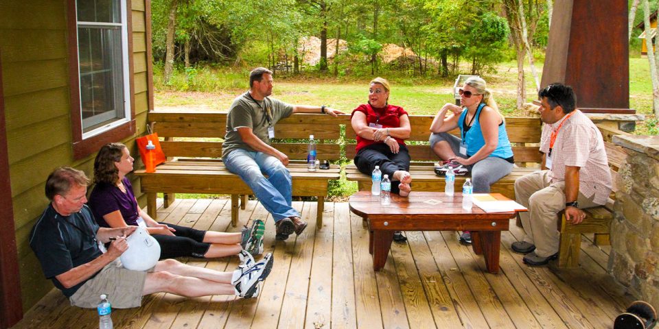 adults hang out on the cabin's oversized porches to have discussion time