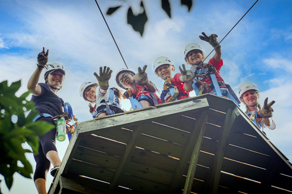 senior day campers peer over the edge of the Zipline Canopy Tour during summer camp